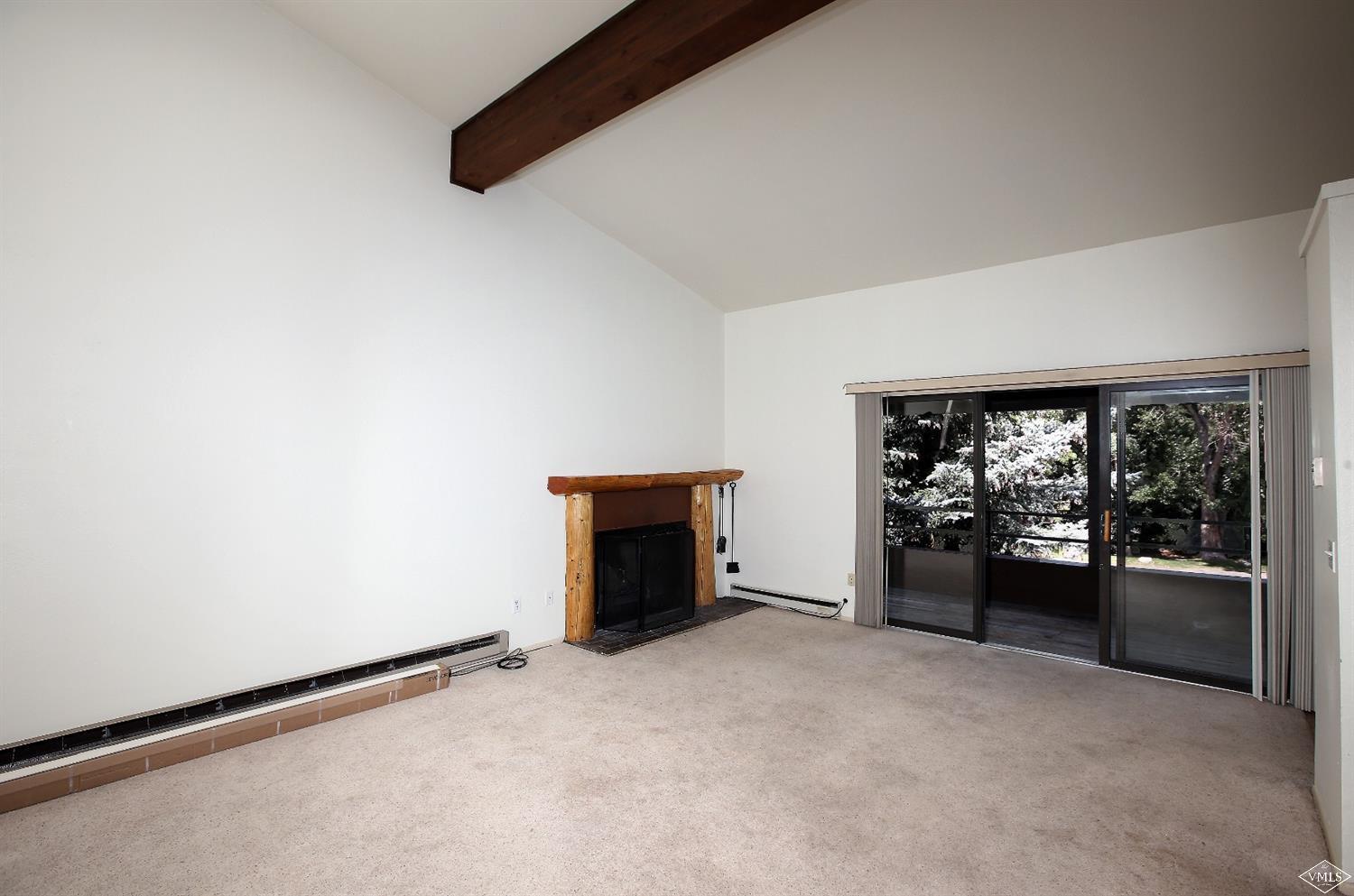 165 Gopher Road, Unit E28 Avon, CO 81620 - Photo 2 of 19 an empty room with furniture and a floor to ceiling window
