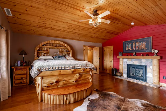 a bedroom with a bed and a fireplace