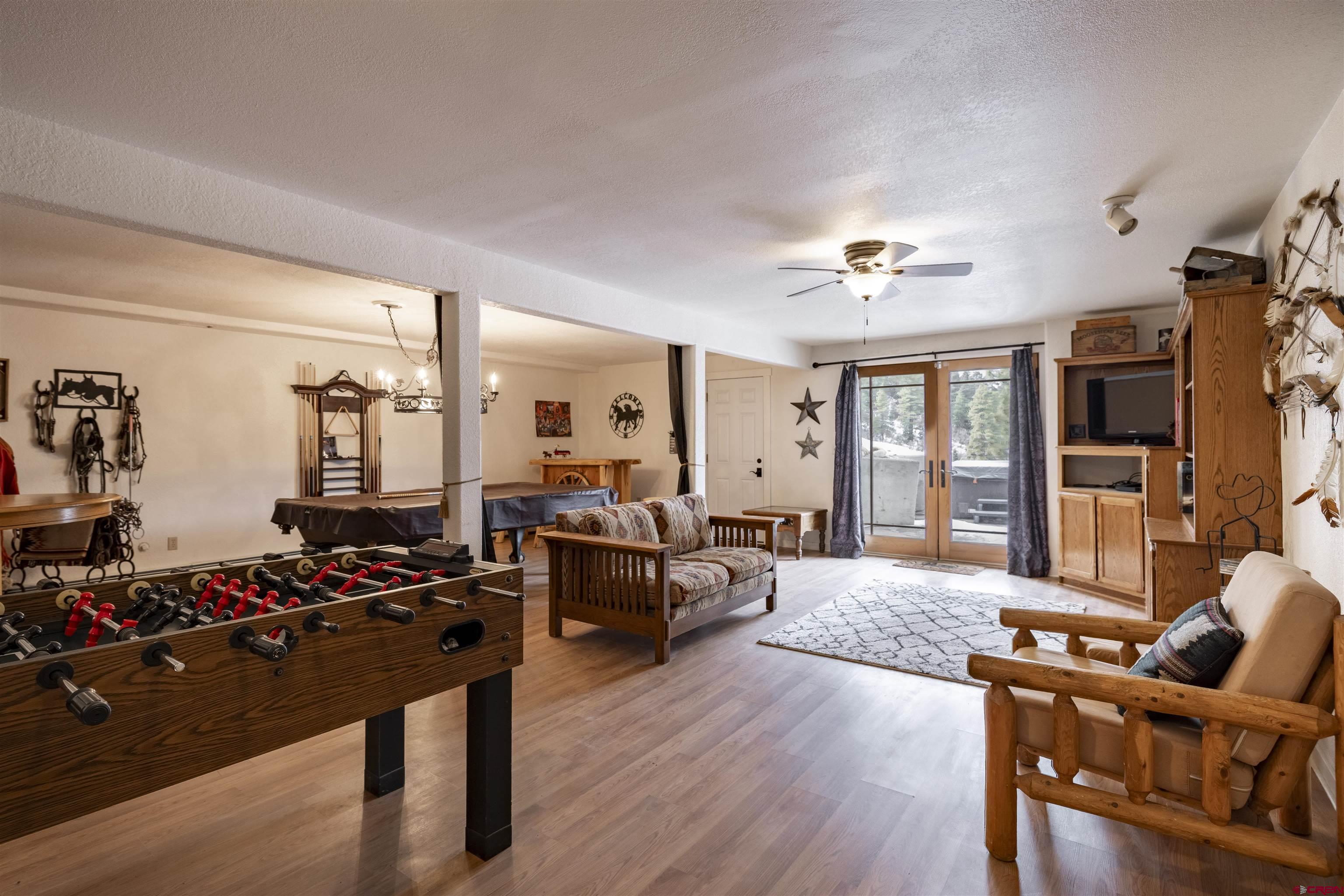 250 Sunset Lane Durango, CO 81301 - Photo 25 of 44 a living room with furniture flat screen tv and wooden floor