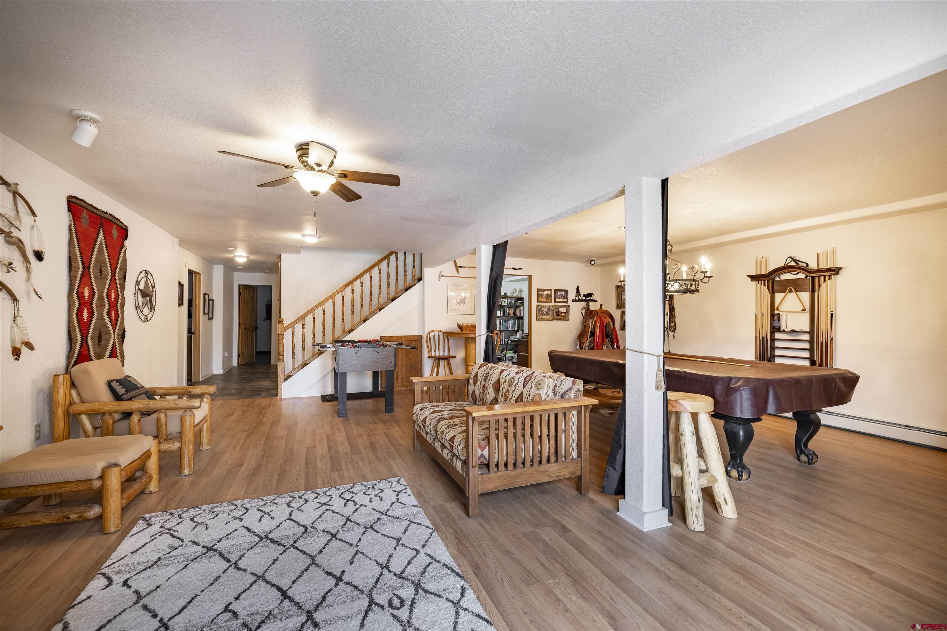 250 Sunset Lane Durango, CO 81301 - Photo 26 of 44 a living room with furniture a rug and white walls