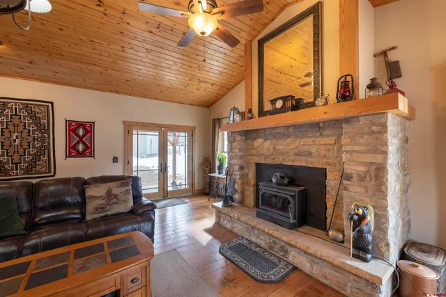 a living room with furniture a fireplace and a table