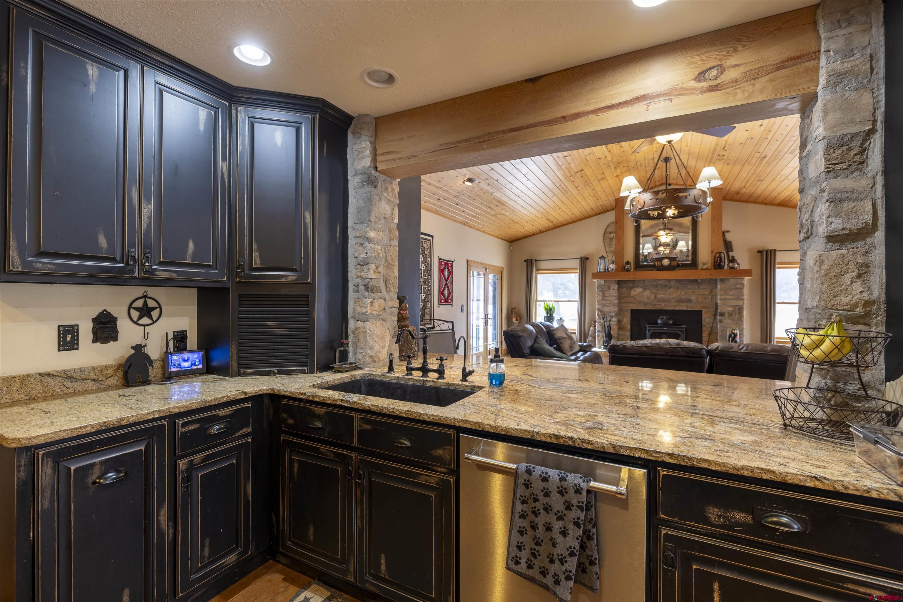 250 Sunset Lane Durango, CO 81301 - Photo 8 of 44 a kitchen with granite countertop a sink stove and cabinets