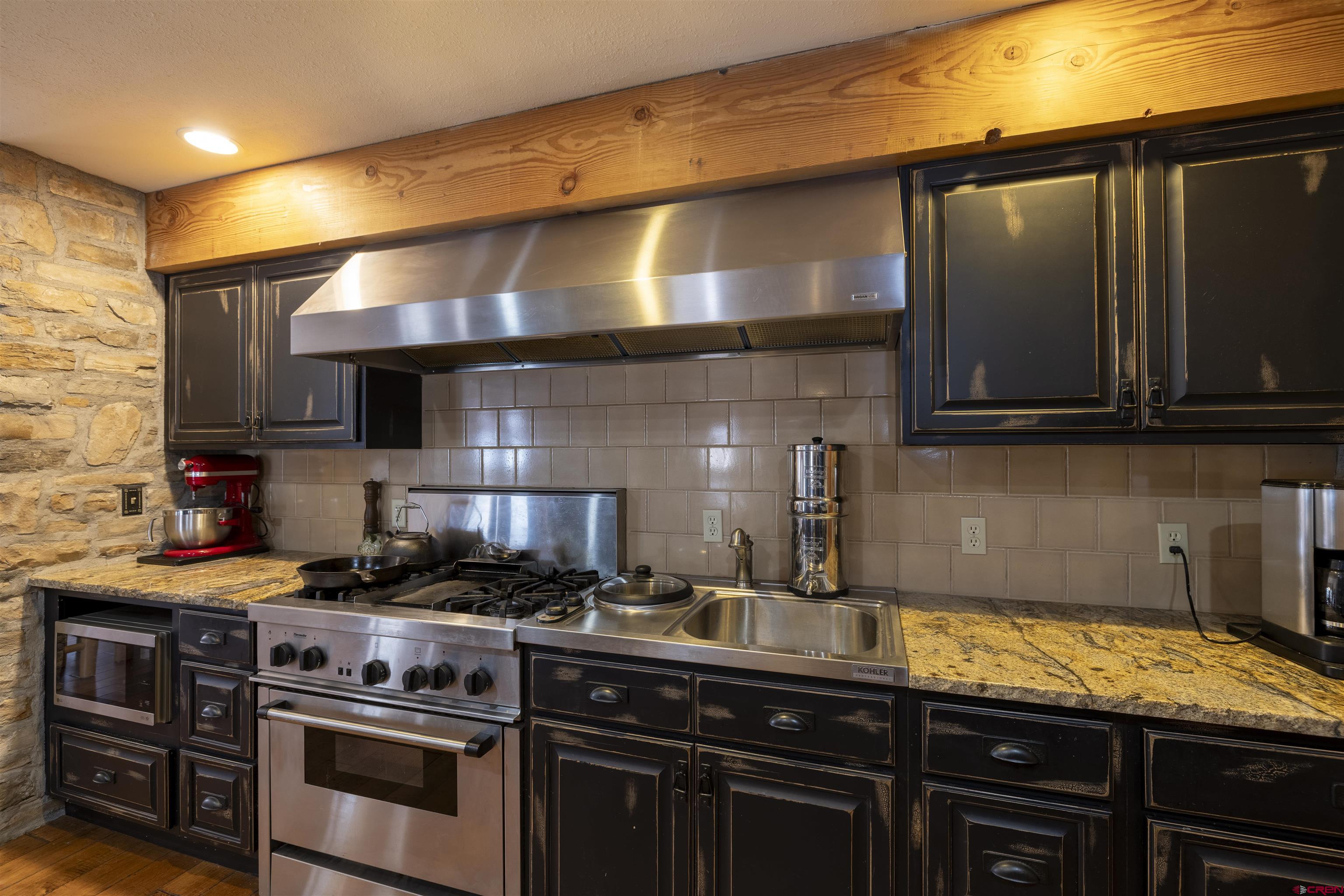 250 Sunset Lane Durango, CO 81301 - Photo 9 of 44 a kitchen with stainless steel appliances granite countertop a stove and a microwave