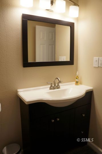 518 South Sanders Street Ridgecrest, CA 93555 - Photo 12 of 14 a bathroom with a sink and a mirror