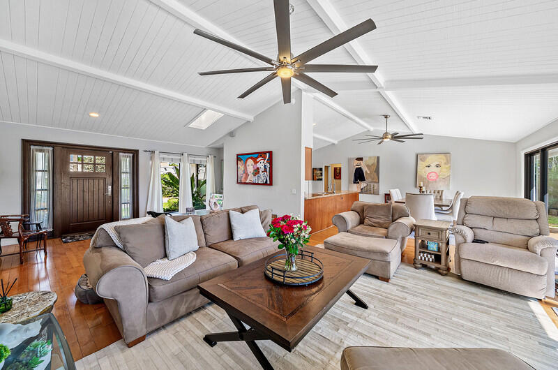 3026 Northeast 6th Drive Boca Raton, FL 33431 - Photo 14 of 49 a living room with furniture kitchen and a chandelier