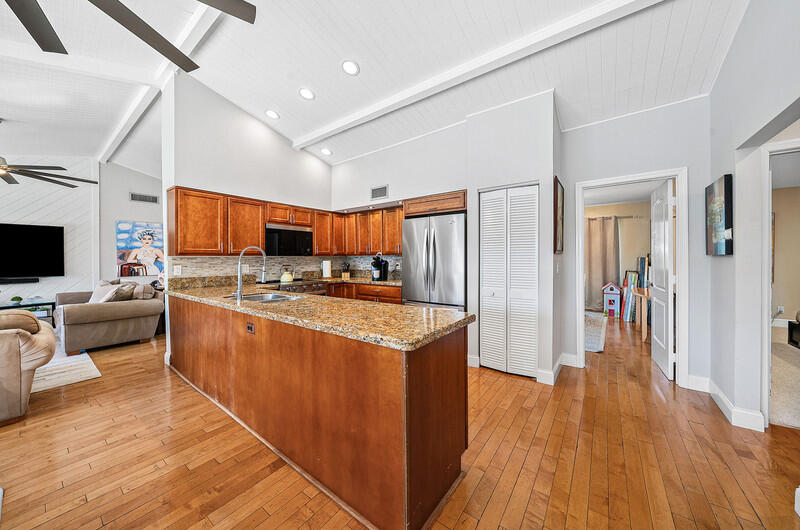 3026 Northeast 6th Drive Boca Raton, FL 33431 - Photo 20 of 49 a open kitchen with stainless steel appliances granite countertop a lot of cabinets and wooden floor