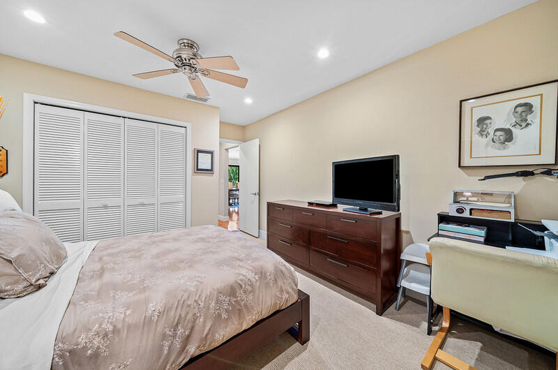 3026 Northeast 6th Drive Boca Raton, FL 33431 - Photo 32 of 49 a bedroom with a bed and a couch