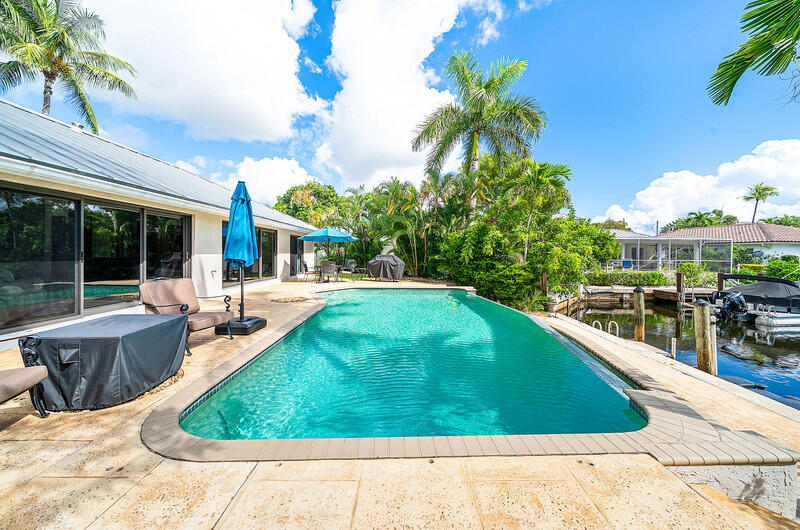 3026 Northeast 6th Drive Boca Raton, FL 33431 - Photo 7 of 49 a view of a swimming pool with a patio