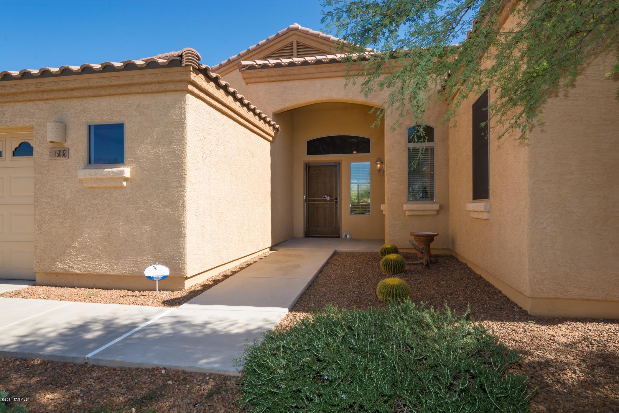 15082 North Holsteiner Road Tucson, AZ 85739 - Photo 7 of 34 a front view of a house with a yard