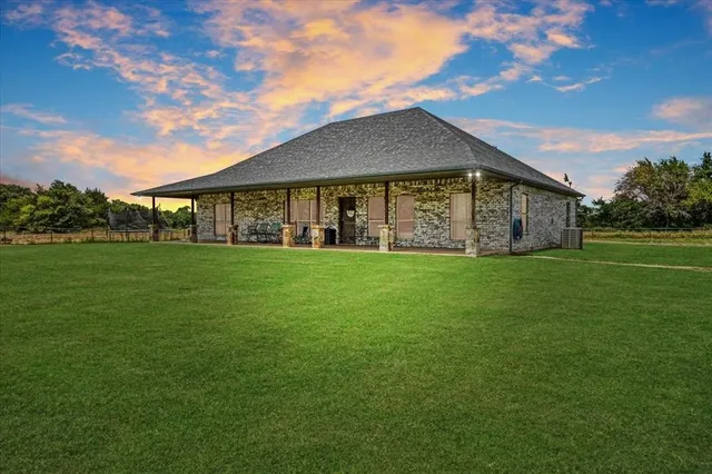 a front view of house with yard and green space