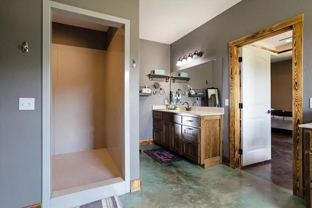 a bathroom with a sink a toilet and mirror