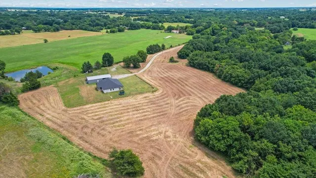 a backyard of a house with a yard and outdoor seating