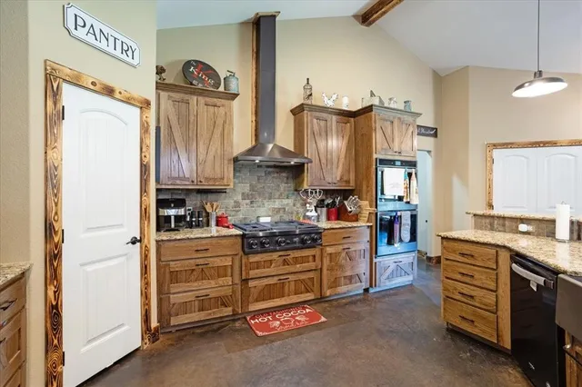 a kitchen with stainless steel appliances granite countertop a stove and a refrigerator
