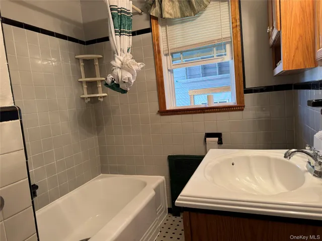 a bathroom with a sink a mirror and a bathtub