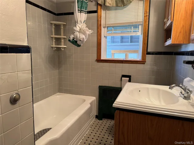 a bathroom with a sink a bathtub and a shower