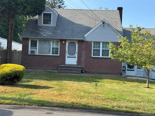 a view of a house with swimming pool and a yard