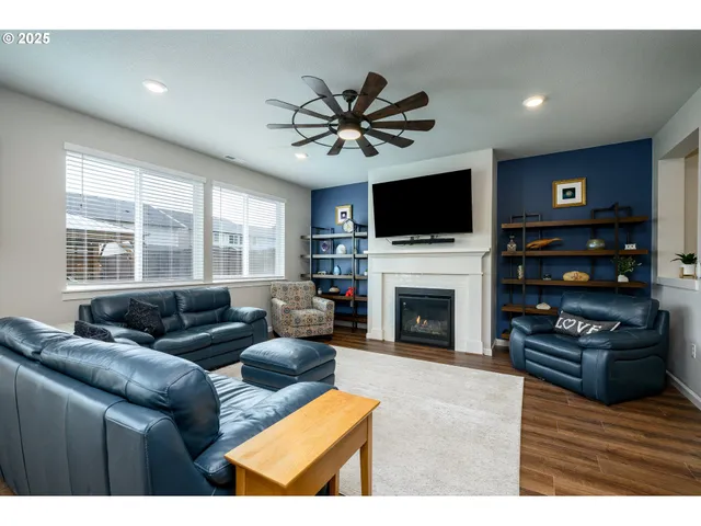 a living room with furniture fireplace and flat screen tv