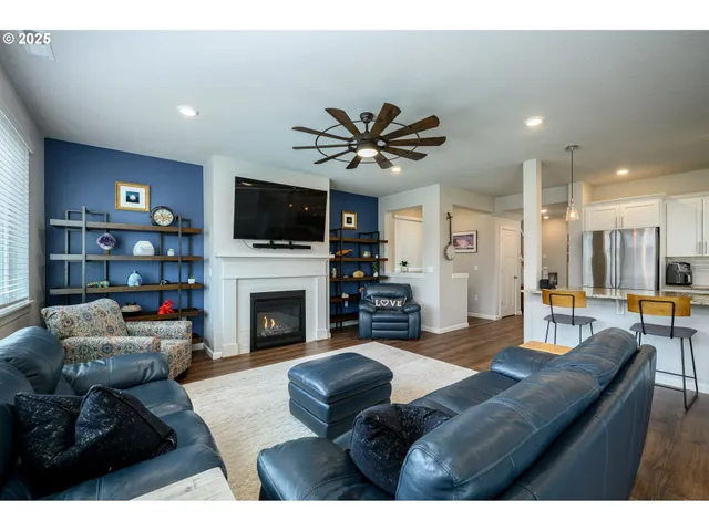 a living room with furniture and kitchen view