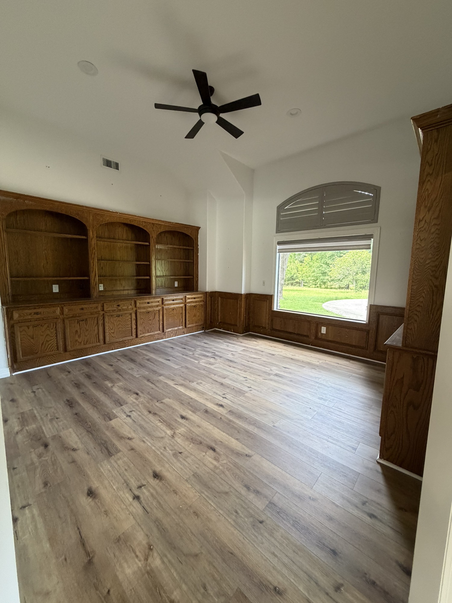 10210 Stidham Road Conroe, TX 77302 - Photo 16 of 39 a view of a livingroom with a flat screen tv wooden floor and a window