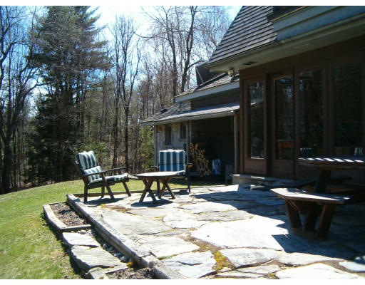 85 Buffam Road Pelham, MA 01002 - Photo 4 of 12 a patio with table and chairs and potted plants