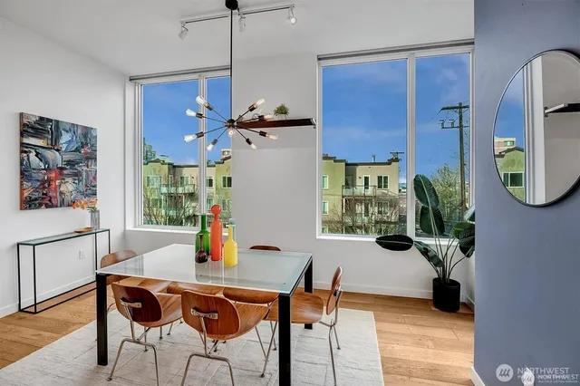 a view of a dining room with furniture and a potted plant