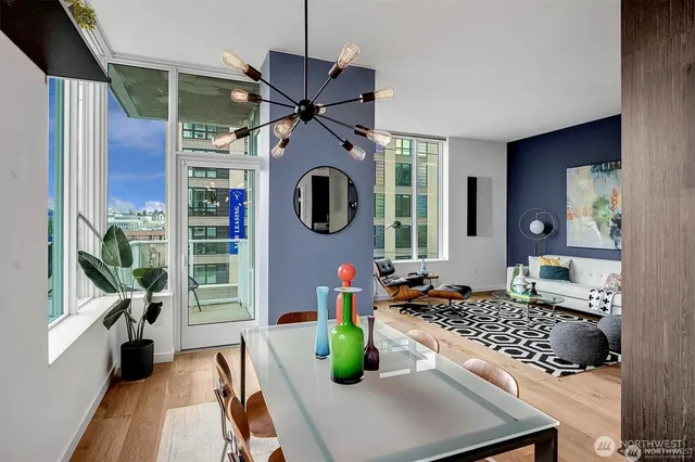 a kitchen view with wooden floor dining table and chairs