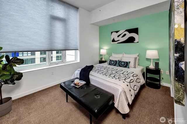 a bedroom with a bed and a potted plant