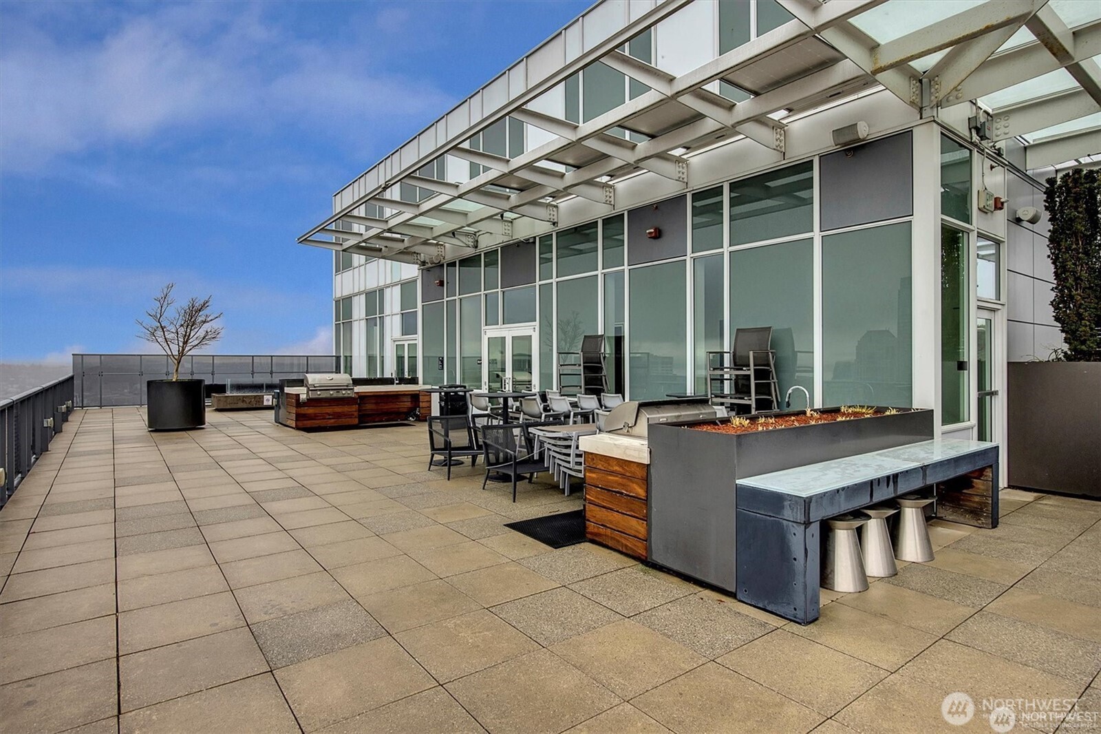 1321 Seneca Street, Unit 401 Seattle, WA 98101 - Photo 25 of 39 a view of a patio with dining table and chairs with wooden floor