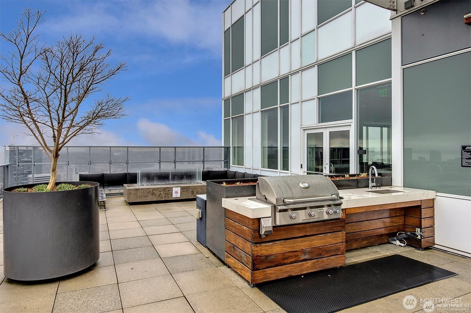 1321 Seneca Street, Unit 401 Seattle, WA 98101 - Photo 26 of 39 a view of a roof deck with couches and fire pit