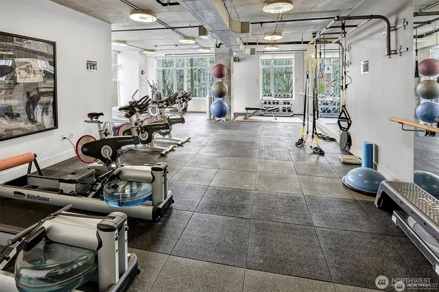 a room with gym equipment and large mirror