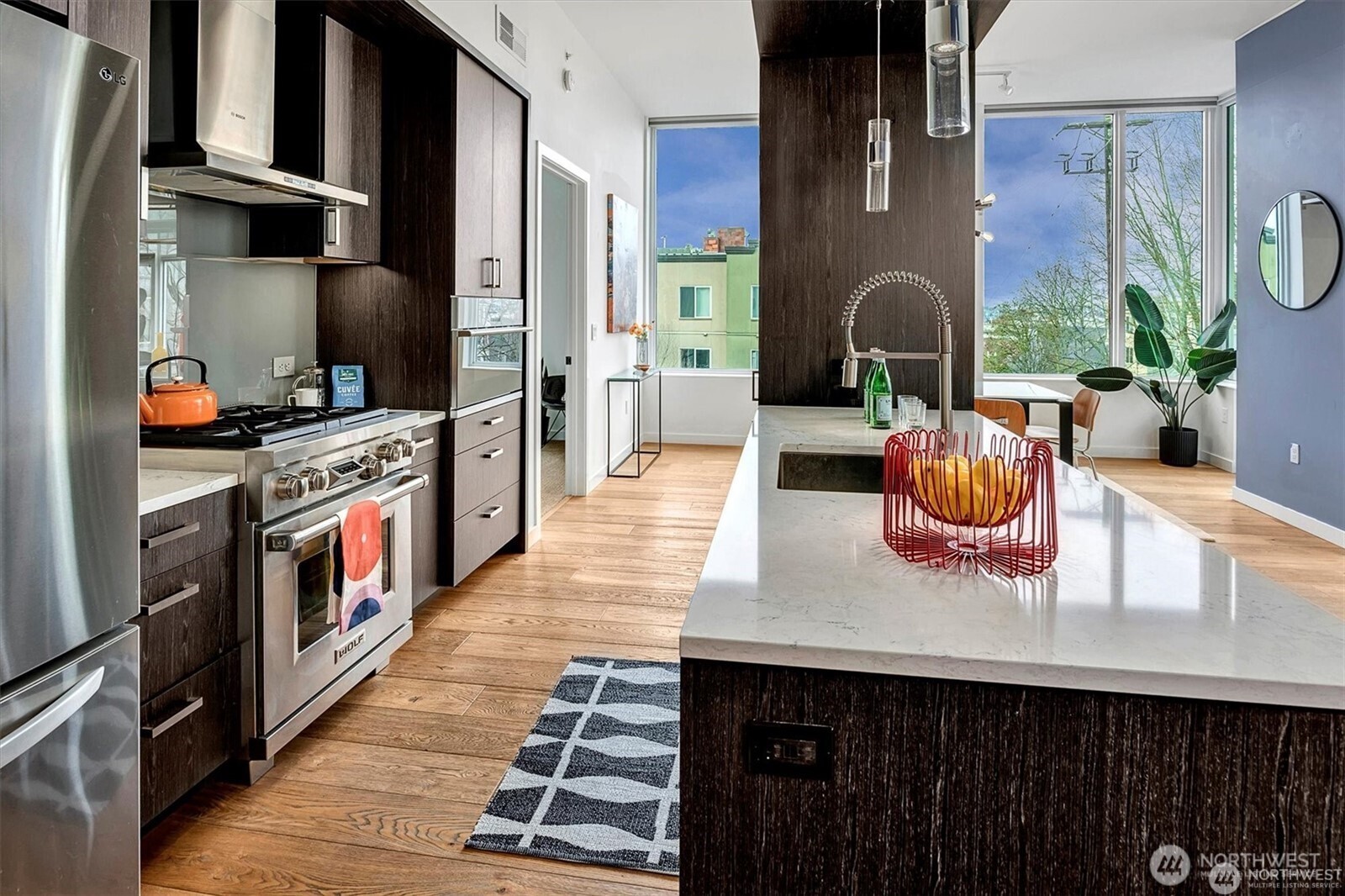 1321 Seneca Street, Unit 401 Seattle, WA 98101 - Photo 6 of 39 a open kitchen with stainless steel appliances granite countertop a stove and a refrigerator