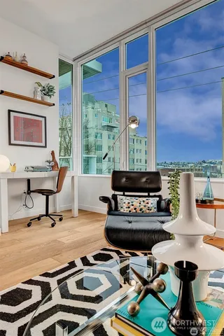 a living room with furniture and a floor to ceiling window