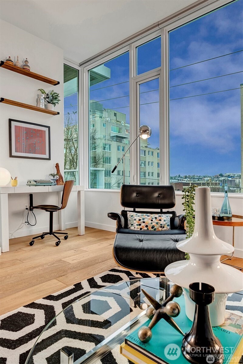 1321 Seneca Street, Unit 401 Seattle, WA 98101 - Photo 9 of 39 a living room with furniture and a floor to ceiling window