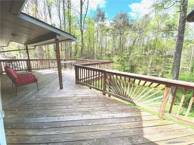 a view of a balcony with mountain view and wooden floor