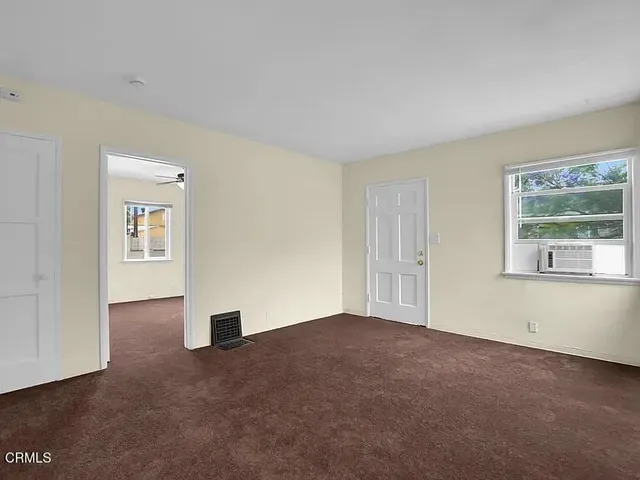 a view of an empty room with a window