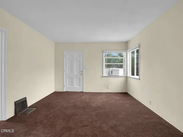 a view of an empty room with windows