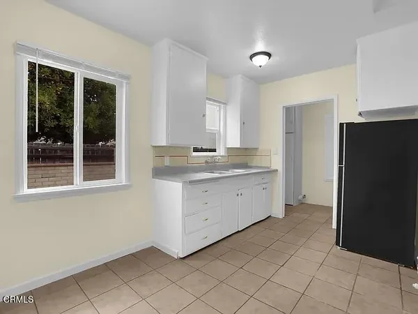 a kitchen with a refrigerator and window