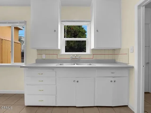 a bathroom with a sink granite and a window