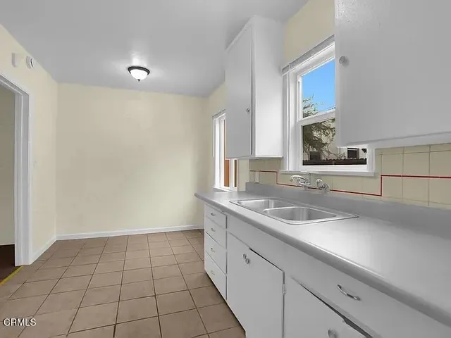 a kitchen with a sink and cabinets