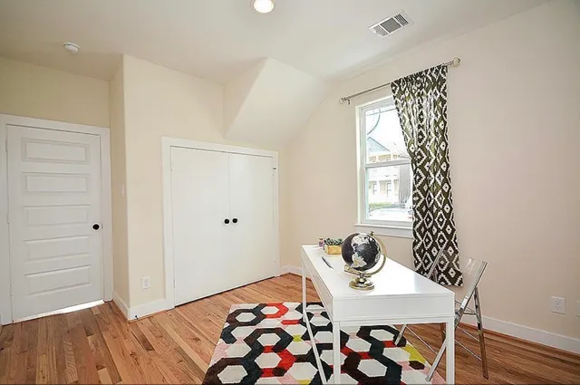 a bedroom with a bed and a window