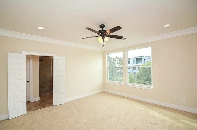 a view of a livingroom with a ceiling fan and window