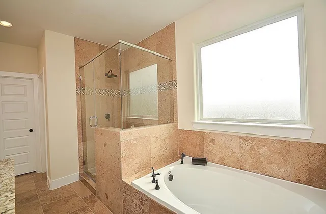 a bathroom with a bathtub and shower
