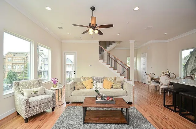 a living room with furniture ceiling fan and a rug