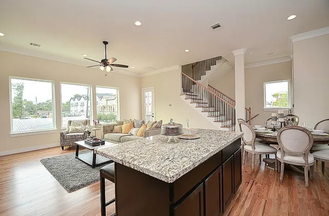 a living room with granite countertop kitchen area and a table