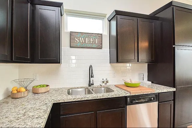 a kitchen with a sink and a refrigerator