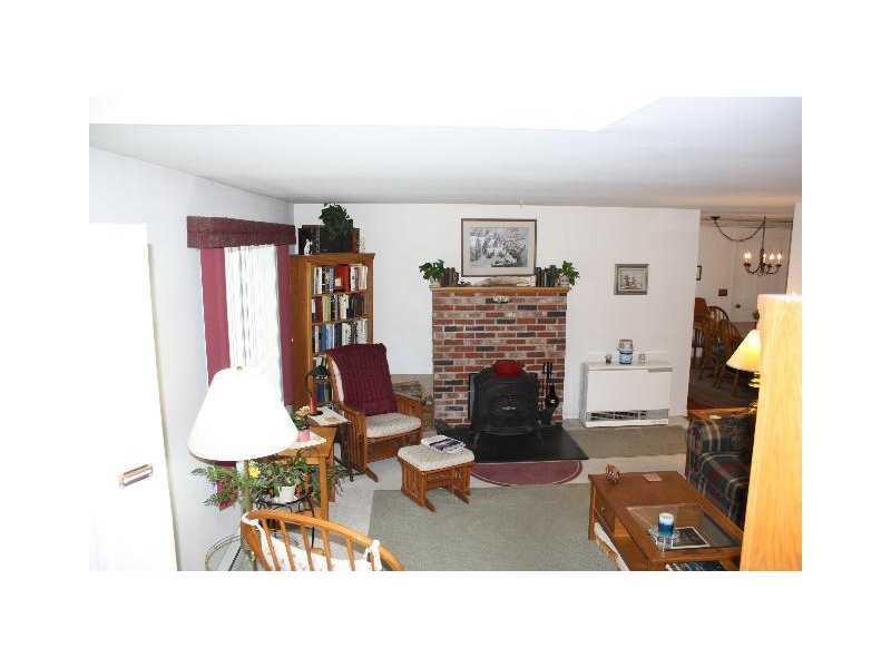 55 Willow Grove Road, Unit 55 Brunswick, ME 04011 - Photo 6 of 28 Living Room. woodstove and hearth,...