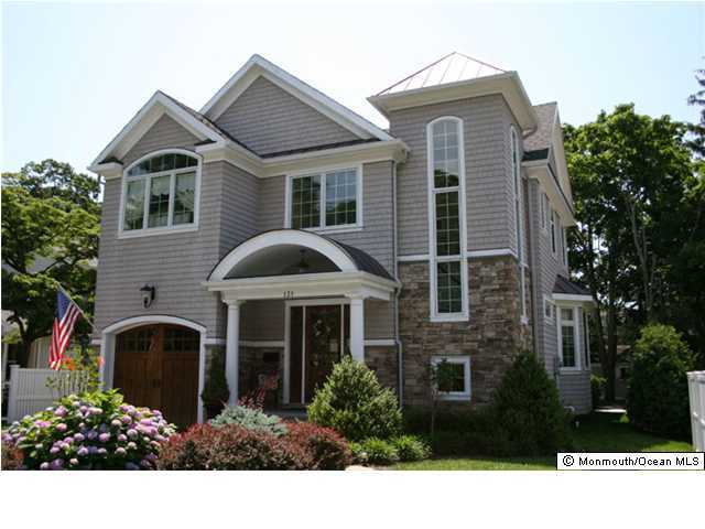 131 Black Point Road Rumson, NJ 07760 - Photo 1 of 3 a front view of a house with garden