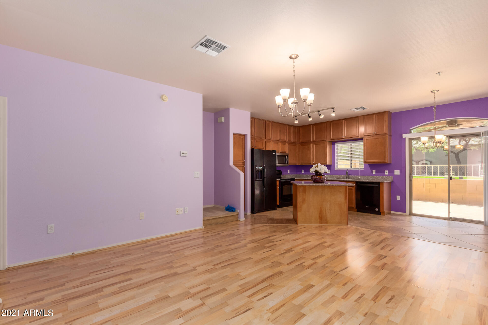 2150 East Bell Road, Unit 1162 Phoenix, AZ 85022 - Photo 3 of 24 a view of a room with painting on the wall and a chandelier