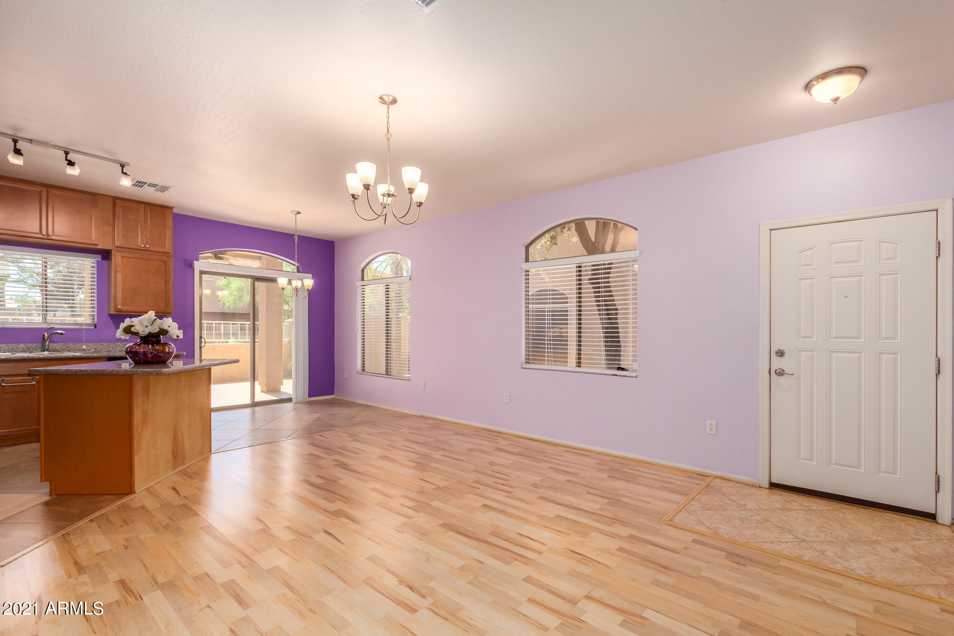 2150 East Bell Road, Unit 1162 Phoenix, AZ 85022 - Photo 4 of 24 a view of a room with chandelier and wooden floors