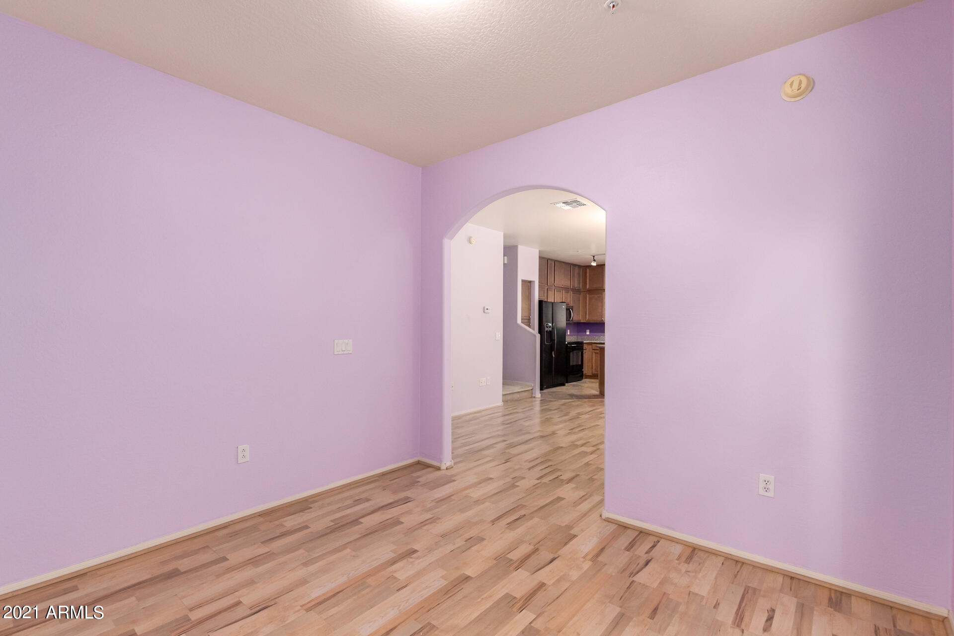 2150 East Bell Road, Unit 1162 Phoenix, AZ 85022 - Photo 6 of 24 a view of a livingroom with wooden floor and a ceiling fan